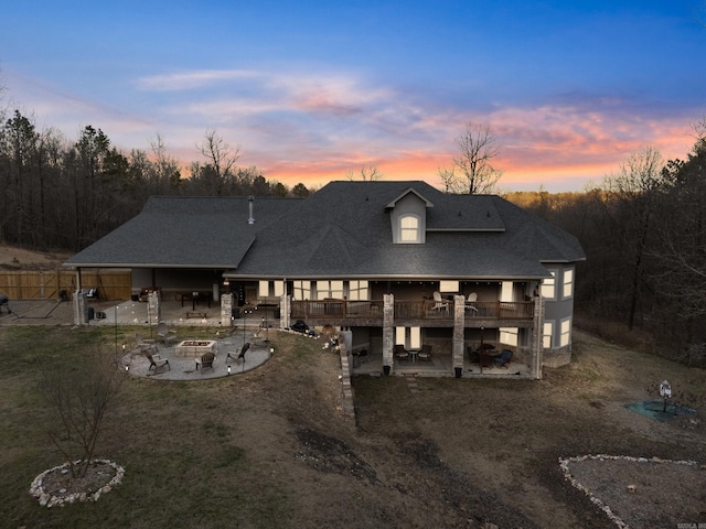 view of front of home featuring a lawn, a patio area, and a fire pit