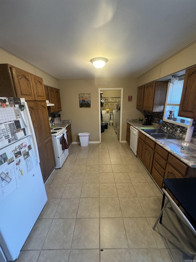 kitchen featuring decorative backsplash, sink, white appliances, and light tile patterned floors