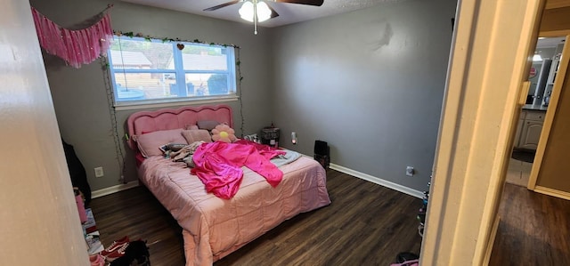 bedroom with ceiling fan and dark hardwood / wood-style floors