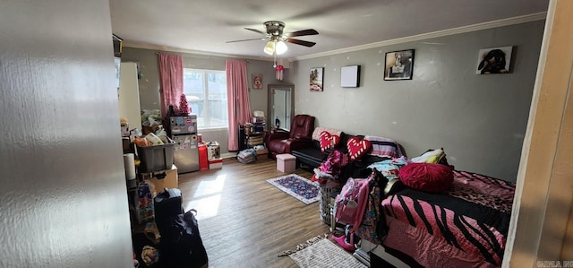 bedroom featuring ceiling fan, hardwood / wood-style flooring, and crown molding