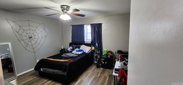 bedroom with ceiling fan and wood-type flooring