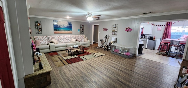 living room featuring ceiling fan, light hardwood / wood-style flooring, and ornamental molding