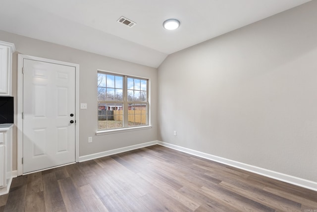 foyer entrance featuring vaulted ceiling and hardwood / wood-style floors