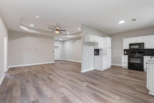 kitchen with black appliances, ceiling fan, white cabinetry, and light hardwood / wood-style flooring