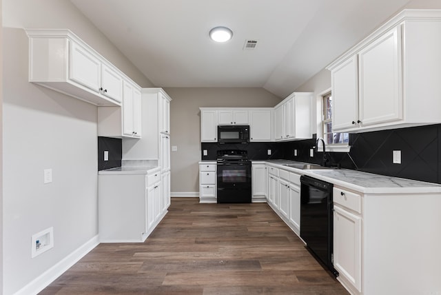 kitchen with black appliances, sink, light stone counters, and white cabinetry