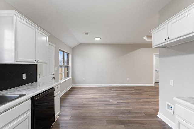 kitchen with tasteful backsplash, black dishwasher, white cabinets, and light stone counters