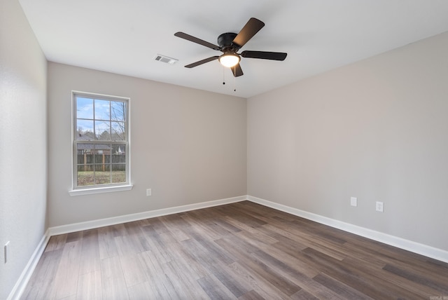 empty room with ceiling fan and hardwood / wood-style floors