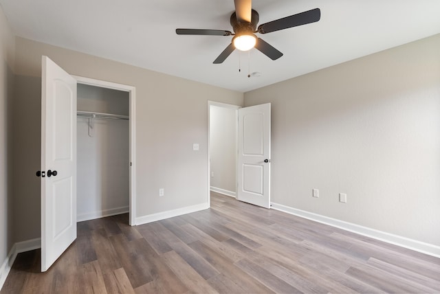 unfurnished bedroom featuring ceiling fan, hardwood / wood-style floors, and a closet