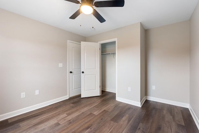 unfurnished bedroom featuring dark wood-type flooring, ceiling fan, and a closet