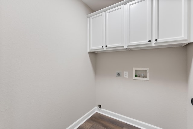 clothes washing area with washer hookup, cabinets, dark hardwood / wood-style flooring, and electric dryer hookup