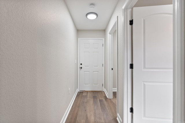 hall with hardwood / wood-style floors