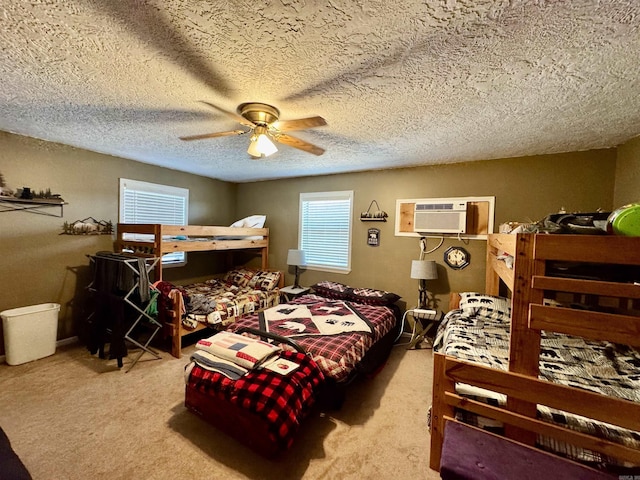 bedroom with ceiling fan, a textured ceiling, light carpet, and a wall mounted AC