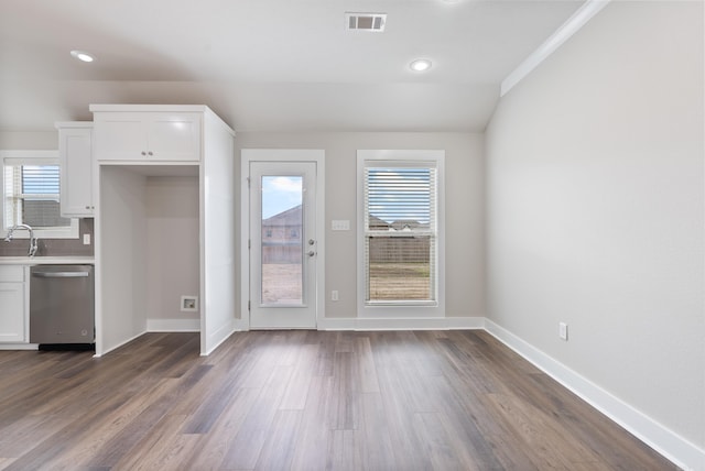 interior space featuring a wealth of natural light, white cabinetry, and dishwasher