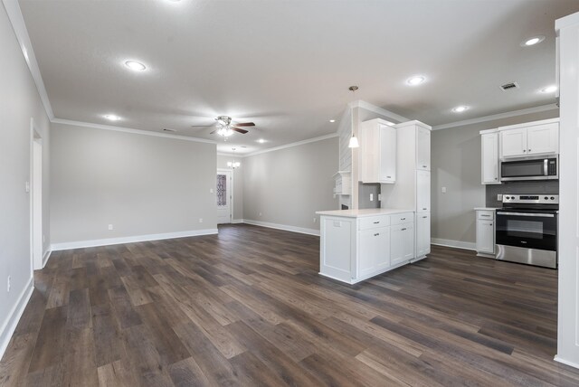 kitchen with ceiling fan, appliances with stainless steel finishes, dark wood-type flooring, ornamental molding, and white cabinets