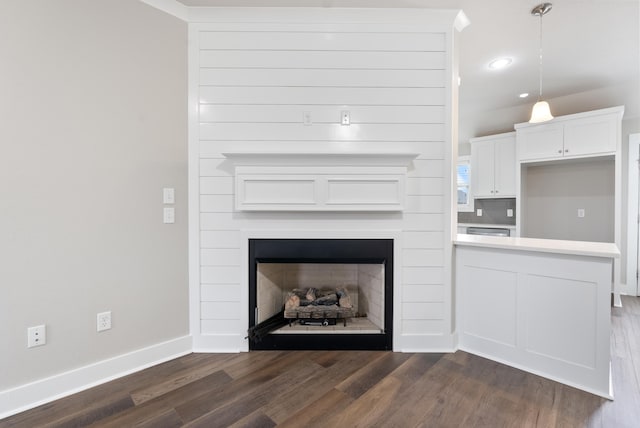 interior space featuring dark hardwood / wood-style floors, white cabinets, and decorative light fixtures