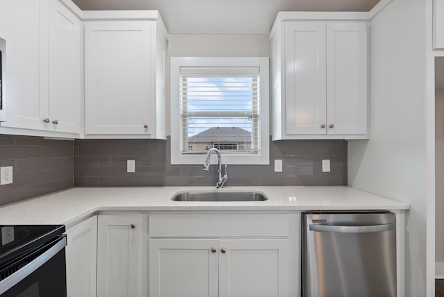 kitchen with decorative backsplash, stainless steel dishwasher, white cabinets, light stone counters, and sink