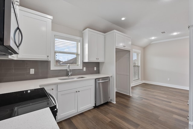 kitchen with tasteful backsplash, sink, stainless steel appliances, and white cabinetry