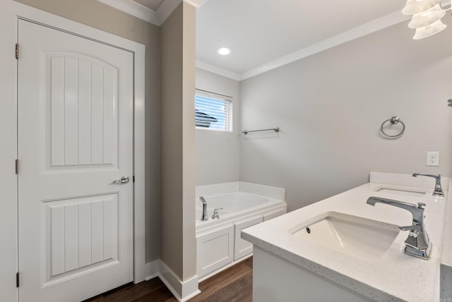 bathroom featuring a washtub, wood-type flooring, vanity, and crown molding