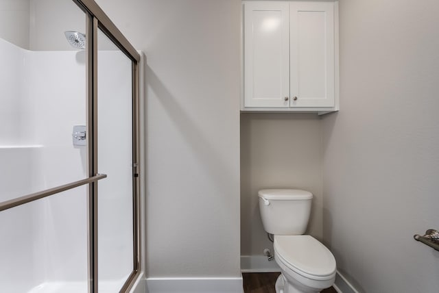 bathroom with toilet and walk in shower