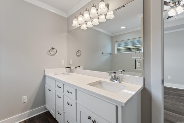 bathroom with hardwood / wood-style flooring, vanity, ornamental molding, and ceiling fan