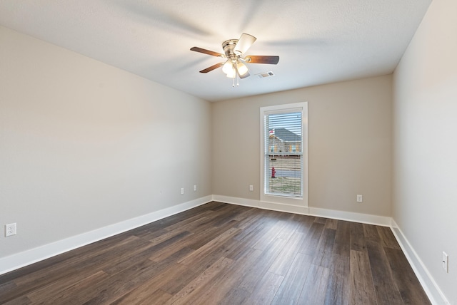 spare room featuring ceiling fan and dark hardwood / wood-style flooring