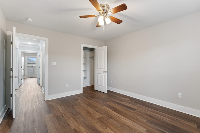 unfurnished bedroom with ceiling fan, dark hardwood / wood-style flooring, and a closet