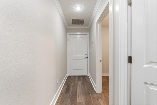 hallway featuring hardwood / wood-style floors, crown molding, and a textured ceiling