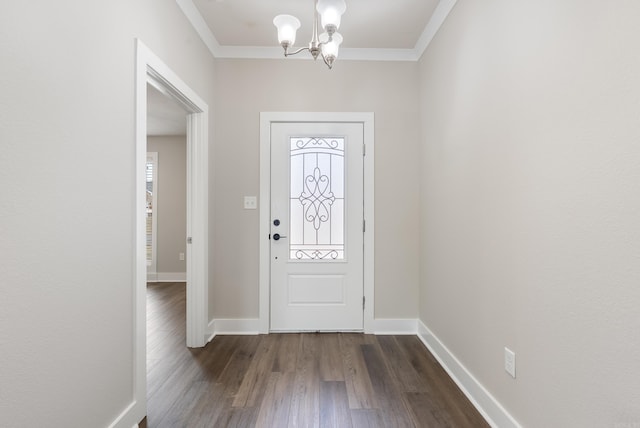 foyer entrance with ornamental molding, a chandelier, and dark hardwood / wood-style flooring