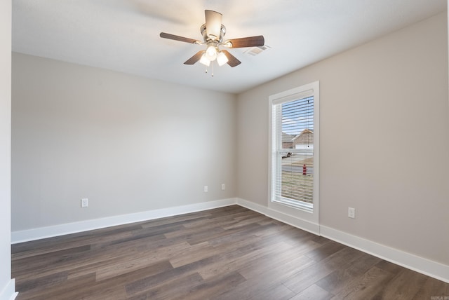 spare room featuring ceiling fan and dark wood-type flooring