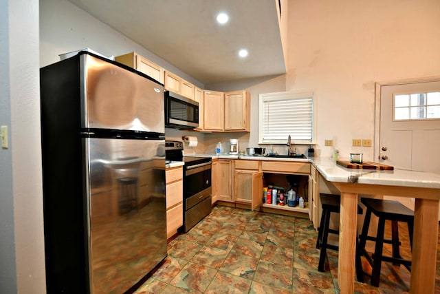 kitchen featuring appliances with stainless steel finishes, tile countertops, light brown cabinets, and sink