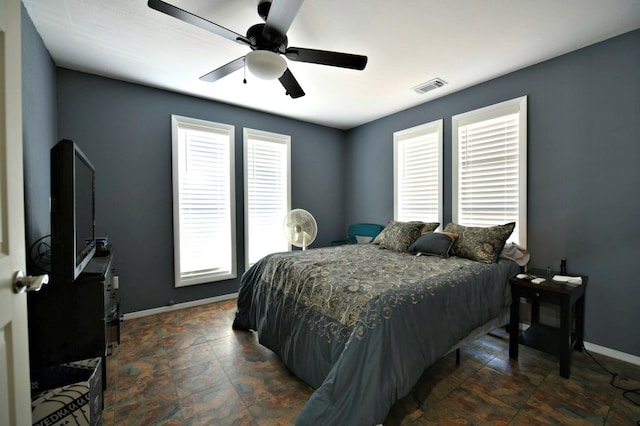 bedroom featuring ceiling fan and multiple windows