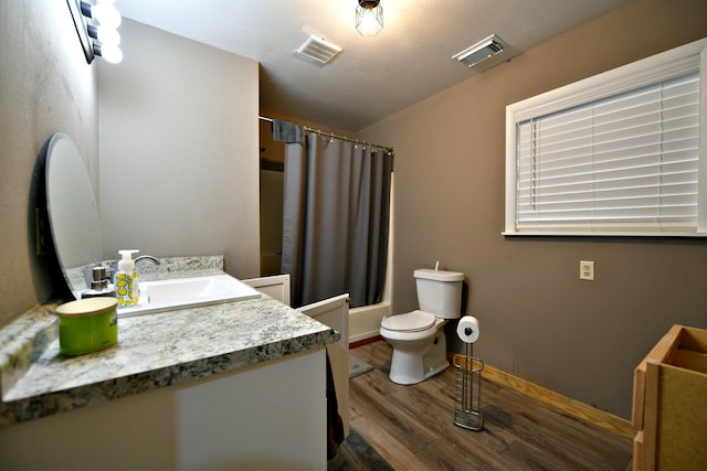 full bathroom with toilet, vanity, shower / bath combo with shower curtain, and hardwood / wood-style floors