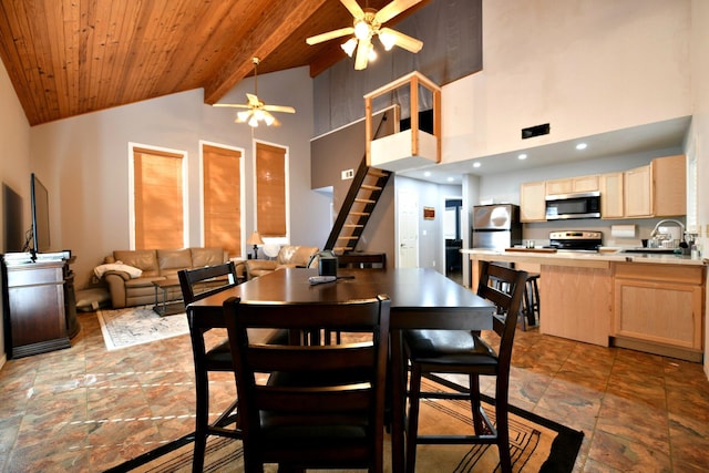 dining space featuring ceiling fan, wood ceiling, beam ceiling, and high vaulted ceiling