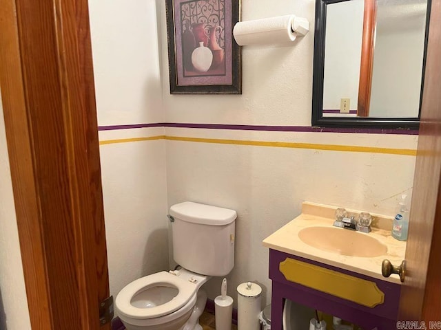 bathroom with toilet and vanity