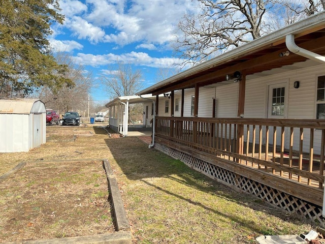 view of yard with a deck and a storage unit