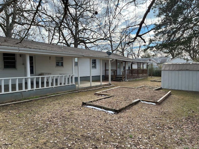 view of yard with a porch and a storage unit