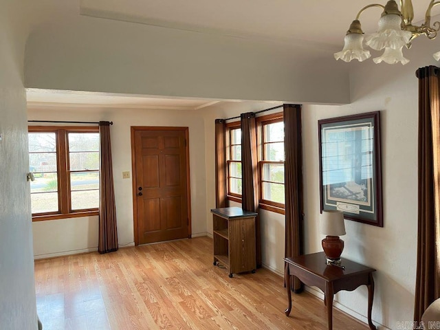 entryway with a notable chandelier and light hardwood / wood-style flooring