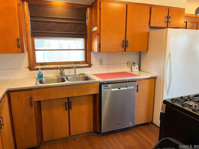 kitchen featuring dishwasher, gas stove, white refrigerator, sink, and dark hardwood / wood-style floors