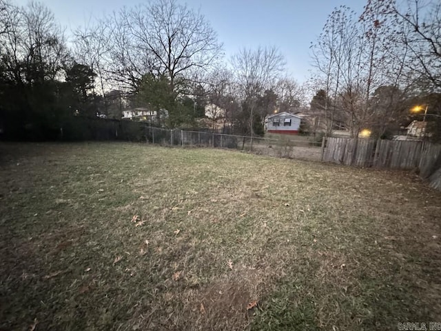 view of yard at dusk