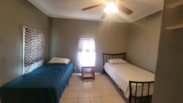 bedroom featuring ceiling fan, light tile patterned floors, and crown molding