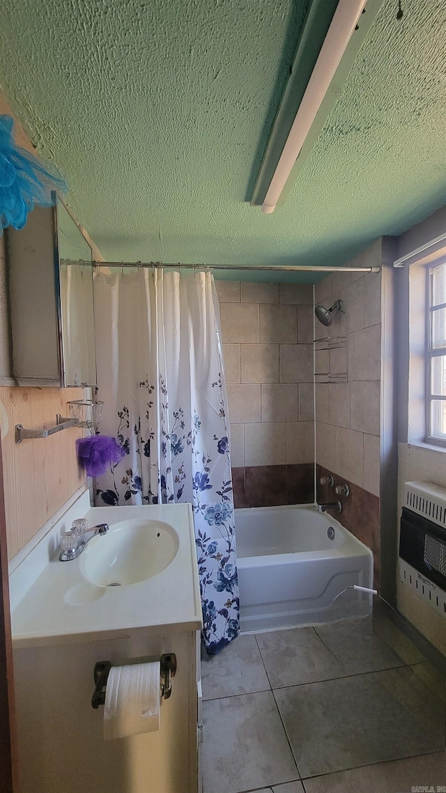 bathroom featuring vanity, tile patterned floors, heating unit, a textured ceiling, and shower / tub combo with curtain