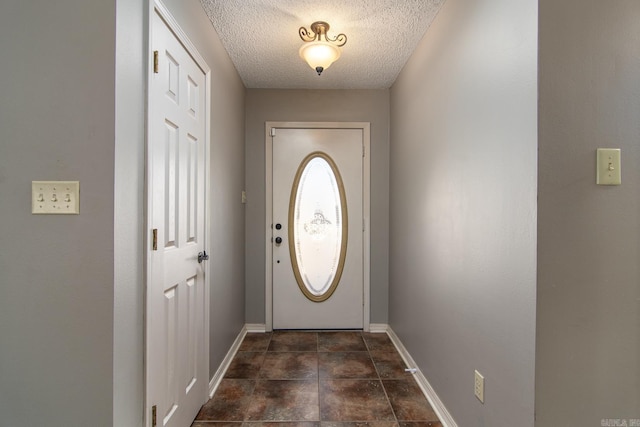 doorway to outside featuring a textured ceiling