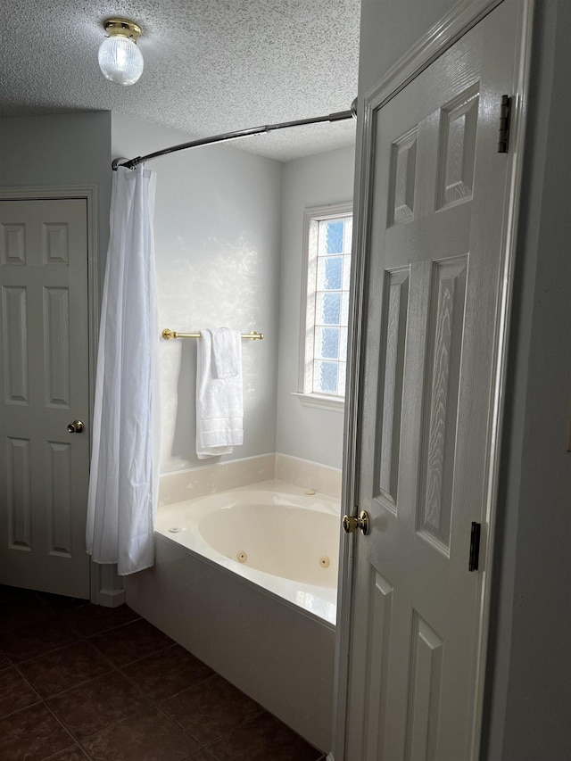 bathroom featuring a textured ceiling, independent shower and bath, and tile patterned flooring