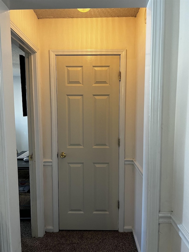 hallway featuring carpet flooring