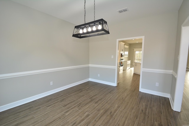 unfurnished dining area with dark hardwood / wood-style floors