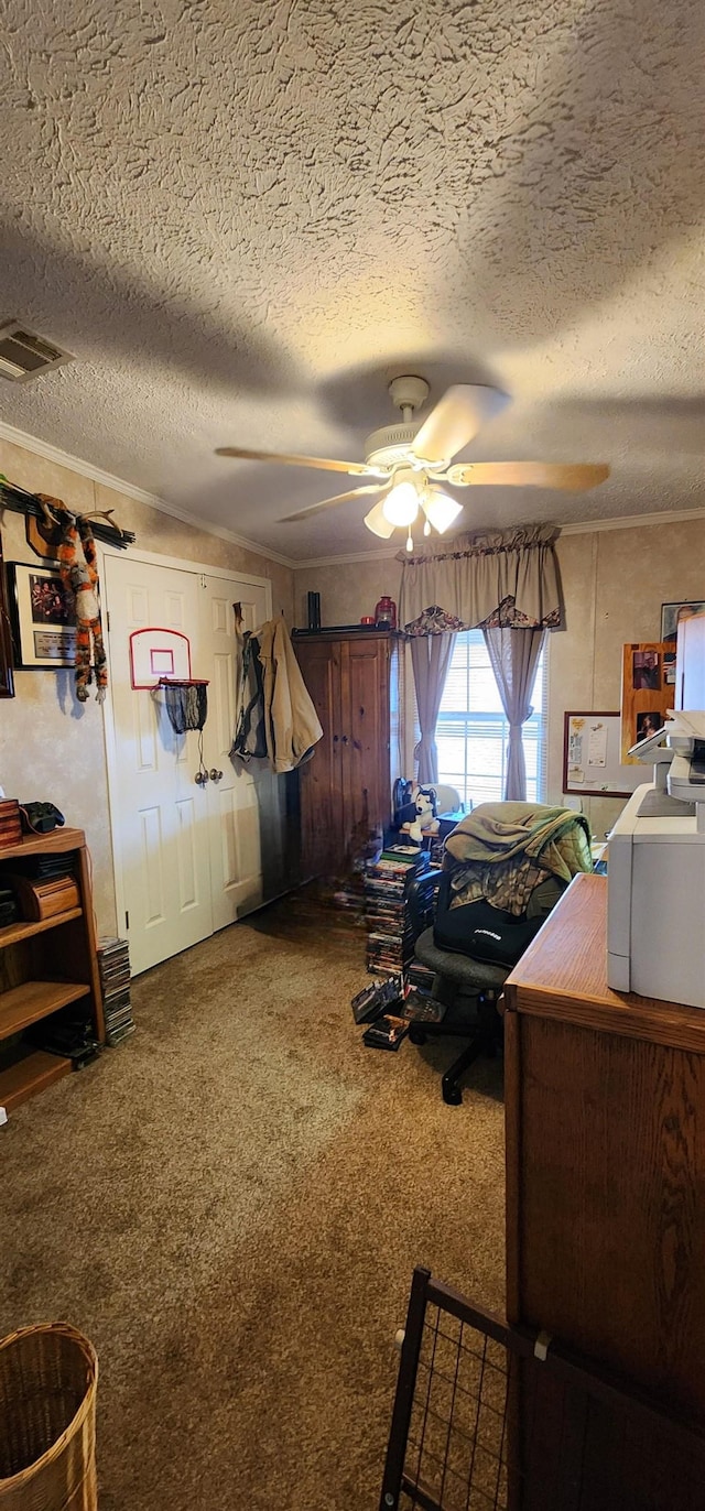 carpeted bedroom featuring a textured ceiling and ceiling fan