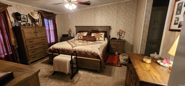 bedroom featuring ceiling fan, carpet, and ornamental molding