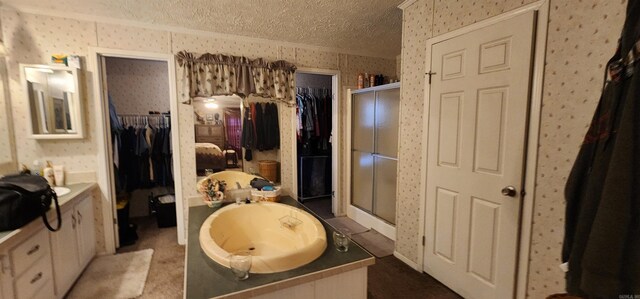 bathroom with a textured ceiling and shower with separate bathtub