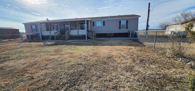 rear view of property with a sunroom and a lawn