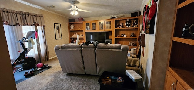 carpeted living room featuring a textured ceiling, ceiling fan, and crown molding